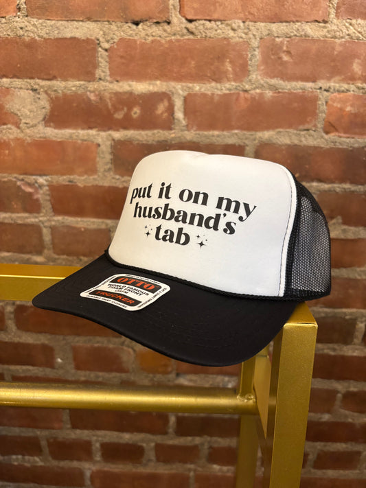 Put it on my husband's tab Trucker Hat